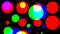 Graphic effect of flashing colored circles on black