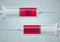 A graphic illustration of two syringes with the words GET VACCINATED with reference to Covid-19 coronavirus or seasonal flu,