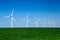 Graphic modern landscape of wind turbines aligned in a field