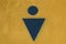 Graphic sign of men`s public toilet blue on yellow background. circle and triangle. concrete texture