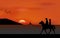 Graphics image the man and women ride horse walking at beach sea with silhouette twilight is a sunset design