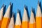 Graphite pencils on a blue background macro photo, school and office supplies