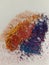 Graphite shavings of yellow red blue and violet