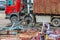 A grapple truck loads scrap industrial metal for recycling.