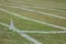 Grass athletics track showing white flag marker