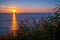 Grass Field in front of the sunset at Leam PromThep Cape in Phuket