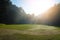 Grass field on hill in sunshine