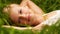 Grass field, nature portrait and happy woman relax, smile or leisure for outdoor stress relief, wellness or park break