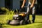 Grass maintenance Man using a mower to trim the yard