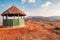 A grass thatched cabin against a Mountain background at Mbeya Rift Valley view point in Mbeya Region, Tanzania