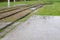 Grass on tram rails in the rain