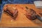 Grassfed prime roast beef on wooden cutting board
