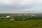 Grassland with abundant water and grass in summer and overcast with clouds.