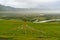 Grassland with abundant water and grass in summer and overcast with clouds.