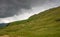 Grassland hill against cloudy sky in the Honister Pass in the Lake District in England UK