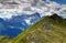 Grassy Carnic Alps with jagged peaks of Sexten Dolomites, Italy