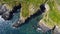 Grassy cliffs on the Atlantic Ocean coast. Landscape of Ireland from a height. Seaside rocks. Drone photo