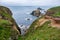 Grassy cliffs overlooking Enys Dodnan Arch