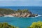 A grassy coastline and a calm seascape view in Koukounaries beach, Skiathos island, Greece