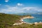 A grassy coastline and a calm seascape view in Koukounaries beach, Skiathos island, Greece