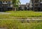 Grassy cobblestone-paved ground before countryside dwelling building