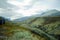 Grassy fields and mountain ranges at the Rondane national park in Norway