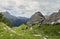 Grassy green high plateau in stony mountains