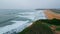 Grassy hill marine landscape drone view. Gloomy beach cliff nature slow motion