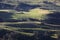 grassy hills and regional land from above with light and shadows in Australia