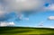 Grassy hillside and gorgeous afternoon cloudscape