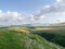 On grassy hillside with valley below to the right