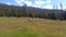 Grassy hilltop, with a stunning backdrop of majestic mountains in the distance