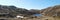 the grassy mountains surrounding a lake and mountain range are rocky