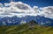 Grassy slopes of Carnic Alps with cliffs of Sexten Dolomites