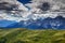Grassy slopes of Carnic Alps and jagged Sesto Dolomiti in Italy