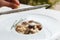 Grate parmesan on wild mushrooms porcini risotto, italian cuisine closeup