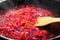 Grated beets in a frying pan. Cooking