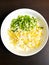 grated boiled egg and green onions in a bowl