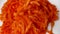 Grated carrot close up rotating very slowly on a plate, stock footage