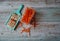 Grated carrots in a bowl, with a grater, on an old wooden table.