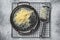 Grated cheese for cooking in a steel tray with grater. White background. Top view