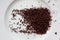 Grated dark chocolate sprinkled on a white plate