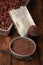 Grated dark chocolate in tin with cocoa beans and solid piece in