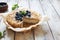 Grated rustic pie with ricotta on natural wooden background