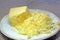 Grated or shredded cheese on a plate.
