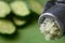 grated squeezed garlic with green cucumber. close-up. macro.