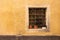 Grated window with an empty flowerpots. Castelsardo, Sardinia, I