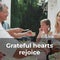 Grateful hearts rejoice text over caucasian family eating thanksgiving dinner outdoors