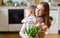 Grateful mother with bouquet hugging son