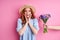 grateful redhead woman is happy to get flowers by suitors